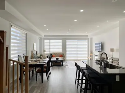 a kitchen and living room with a table and chairs at 3 Bedroom Well-designed Townhouse in Whitby in Whitby
