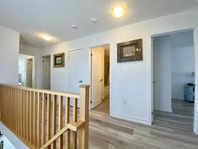 a room with a staircase and aoyer with white walls at 3 Bedroom Well-designed Townhouse in Whitby in Whitby