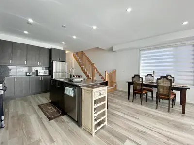 a kitchen and dining room with a table and chairs at 3 Bedroom Well-designed Townhouse in Whitby in Whitby