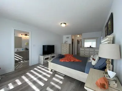 a bedroom with a bed and a television in a room at 3 Bedroom Well-designed Townhouse in Whitby in Whitby