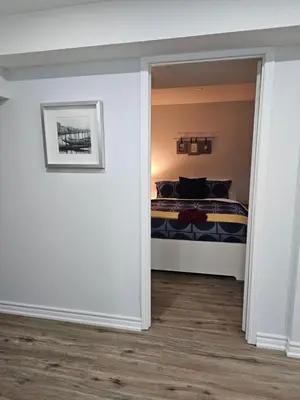 a bedroom with a bed in a room at Poolside entire lower level apt in Whitby