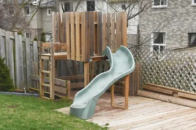 a playground with a slide on a wooden deck at Stylish Home in Prime Location North of Toronto in Richmond Hill