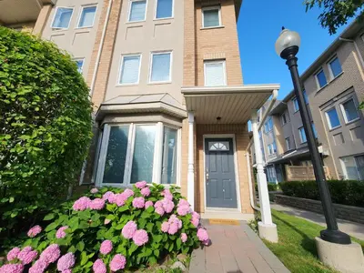 a house with pink flowers in front of it at Scarborough Townhouse in Toronto