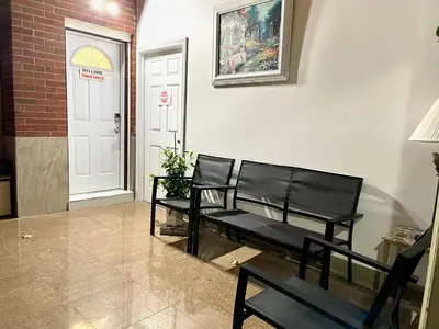 two black benches sitting in front of a door at TononHouse in Toronto
