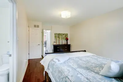 a white bedroom with a bed and a sink at Luxury Home In Castlemore Brampton in Brampton