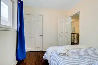 a bedroom with a bed with a blue curtain at Luxury Home In Castlemore Brampton in Brampton