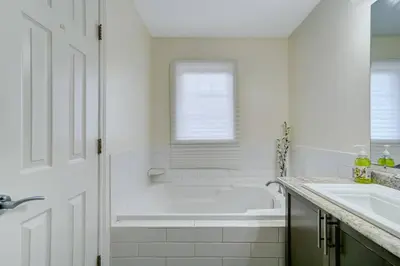 a white bathroom with a tub and a sink at Luxury Home In Castlemore Brampton in Brampton