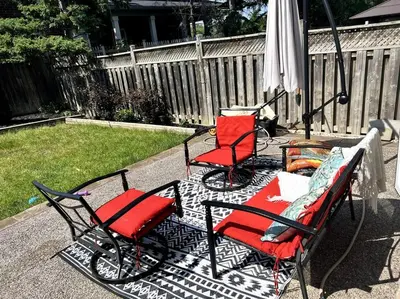 two chairs and an umbrella on a patio at Luxury Home In Castlemore Brampton in Brampton
