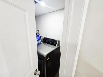 a small kitchen with a stove in a room at Friendly Neighborhood Garden Ave Suite in Brantford