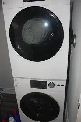 a washing machine with a black bowl on top of it at Comfy basement near KW airport in Kitchener