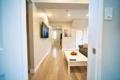 a living room with a couch and a table at Hamilton Oasis - Luxe Beds - BBQ Haven - Pool in Hamilton