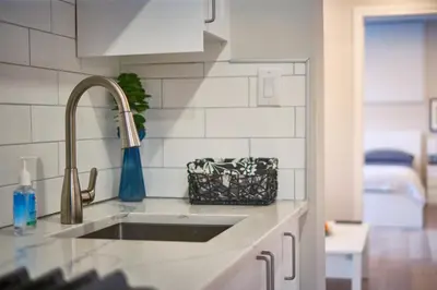 a kitchen with a sink and a counter top at Hamilton Oasis - Luxe Beds - BBQ Haven - Pool in Hamilton