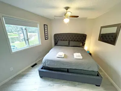 a bedroom with a bed with two towels on it at Forest Retreat - Pool - Games - Fireside Joy in Cayuga