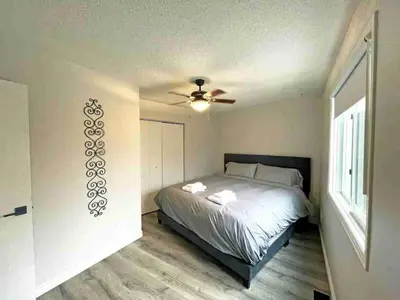 a bedroom with a bed and a ceiling fan at Forest Retreat - Pool - Games - Fireside Joy in Cayuga