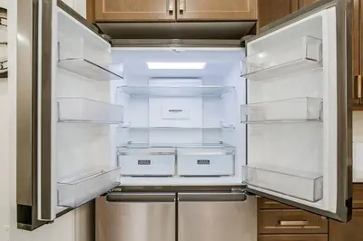 an empty refrigerator with its door open in a kitchen at 922 Logan Drive in Milton