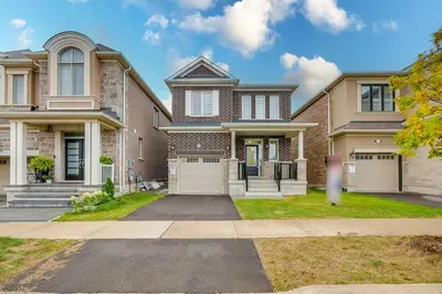 a large brick house with two garage at 922 Logan Drive in Milton