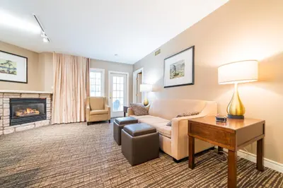 a living room with a couch and a fireplace at Horseshoe Valley Suites - The Aurora in Shanty Bay