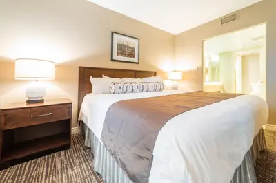 a bedroom with a large bed and a dresser with a mirror at Horseshoe Valley Suites - The Aurora in Shanty Bay