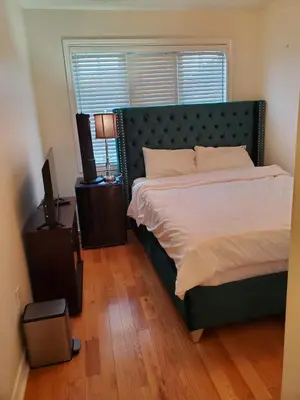 a bedroom with a large bed and a window at RAESABU GUEST HOUSE in Brampton