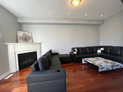 a living room with black furniture and a fireplace at Spacious 5BR Home for Families & Business Travelers in Ajax