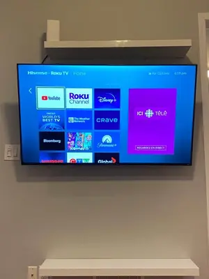 a flat screen tv hanging on a wall at Spacious 5BR Home for Families & Business Travelers in Ajax