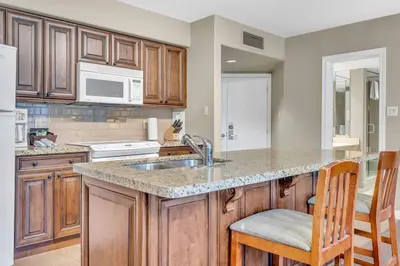 a kitchen with wooden cabinets and a counter top at Spacious Hideaway in Nature in Edgar