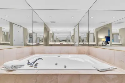 a large bathroom with a large tub with mirrors at Spacious Hideaway in Nature in Edgar