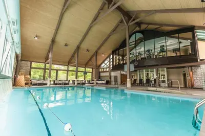 a large swimming pool in a large building at Spacious Hideaway in Nature in Edgar