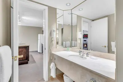 a bathroom with a large sink and a large mirror at Cozy Getaway with Resort Perks in Edgar