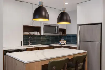 a kitchen with a refrigerator and a counter top at Staybridge Suites Port Elgin by IHG in Port Elgin