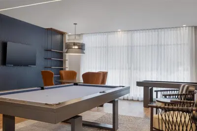 a billiard room with a pool table and chairs at Staybridge Suites Port Elgin by IHG in Port Elgin