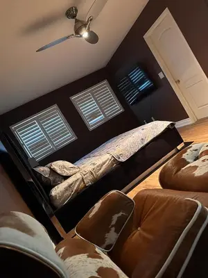 a bedroom with a bed and two windows at Beautiful home in Mississauga