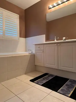 a bathroom with a sink and a mirror at Beautiful home in Mississauga