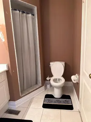 a bathroom with a toilet and a shower at Beautiful home in Mississauga