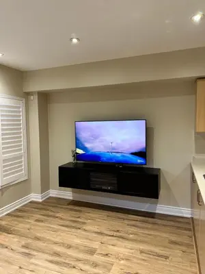 a living room with a flat screen tv on a wall at Beautiful home in Mississauga