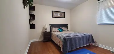 a small bedroom with a bed and a window at Beautiful House in Mississauga in Mississauga