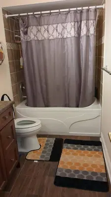 a bathroom with a toilet and a shower curtain at Beautiful House in Mississauga in Mississauga
