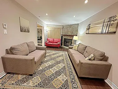 a living room with a couch and a fireplace at Beautiful House in Mississauga in Mississauga