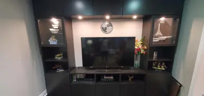 a living room with a flat screen tv and shelves at Beautiful House in Mississauga in Mississauga