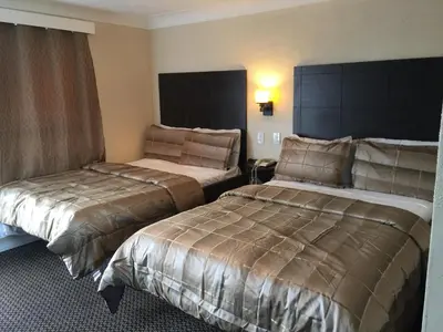 a hotel room with two beds in a room at Mayflower Motel in Kitchener