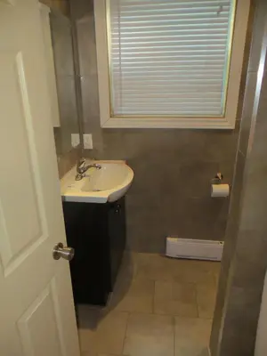 a bathroom with a sink and a window at Mayflower Motel in Kitchener
