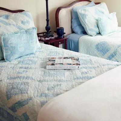 a book sitting on top of a bed at Fells Meadows Farmhouse on Country Property in Castleton