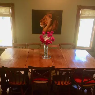 a wooden table with a vase of flowers on it at Fells Meadows Farmhouse on Country Property in Castleton