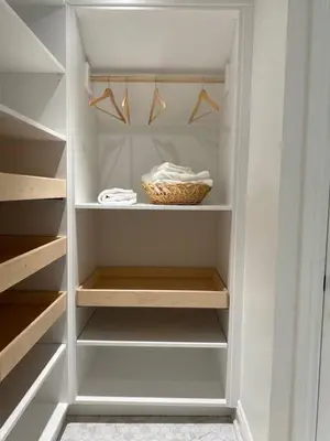 a white closet with wooden shelves and a basket in it at Downtown Picton 3 bedroom in Picton