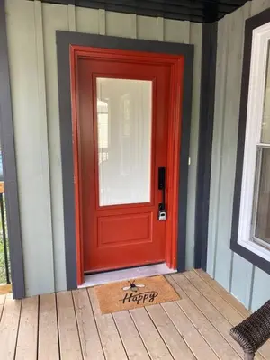 a red door with a happy sign in front of it at Downtown Picton 3 bedroom in Picton