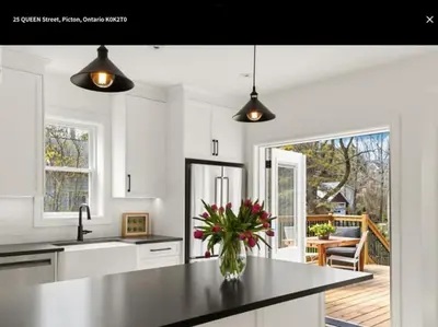 a kitchen with a vase of flowers on a counter at Downtown Picton 3 bedroom in Picton