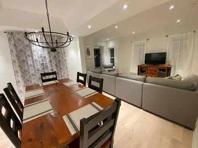 a living room with a table and a couch at Downtown Picton 3 bedroom in Picton