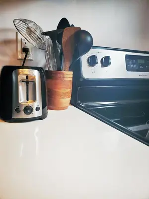 a container of cooking utensils is next to an oven at *NEW: Stylish Wortley 1BR Suite in London