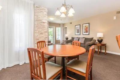 a dining room and living room with a table and chairs at Country Club Charm - 4-Bed Radiant Resort Condo in Edgar