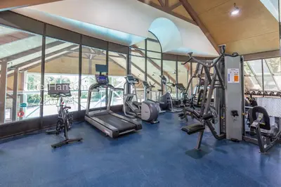 a gym with several treadmills and elliptical machines at Country Club Charm - 4-Bed Radiant Resort Condo in Edgar